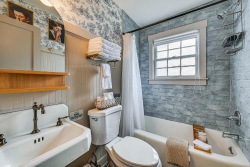 a bathroom with a toilet and a sink and a tub at Chic Elizabethtown Apartment Walk to Downtown! in Elizabethtown