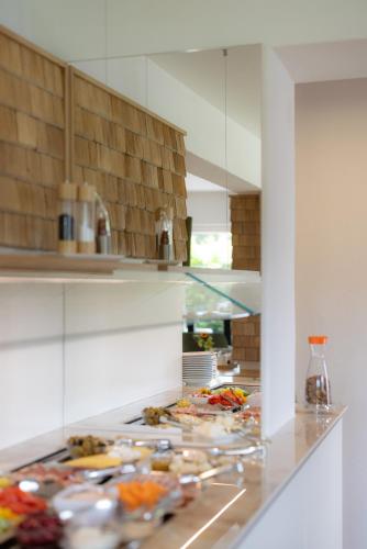 a kitchen with many plates of food on a counter at Hotel Sonne Garni in Hinterzarten