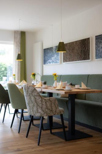 a dining room with a wooden table and chairs at Hotel Sonne Garni in Hinterzarten