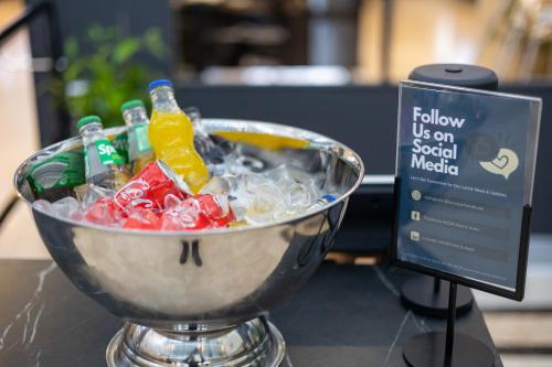 a bowl of soda bottles in a bucket of ice at Solna Park & Hotel in Solna