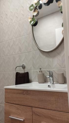 a bathroom with a sink and a mirror at Timón, cerca de la Playa in Candás