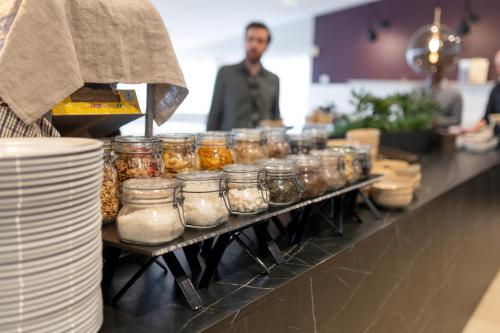 a row of jars of food on a counter at Solna Park & Hotel in Solna
