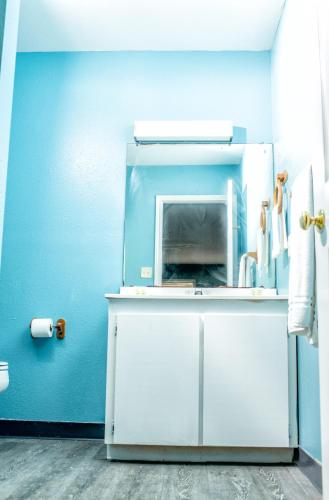 a kitchen with a blue wall and a white refrigerator at captain's quarters in Port O'Connor