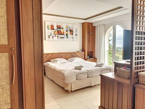 een slaapkamer met een bed en een groot raam bij VILLA VUE MER in Pietrosella