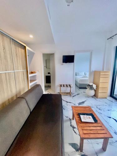 a living room with a couch and a coffee table at Bianco a Nero Mykonos in Mýkonos City
