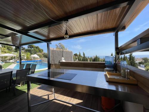 a dining room with a table and a view of a pool at Malagasuite Villa Moriana in Mijas