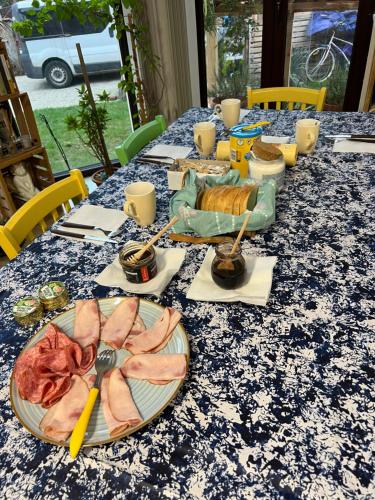 a table with plates of food on a blue table cloth at B&B San Michele in Baia Mare