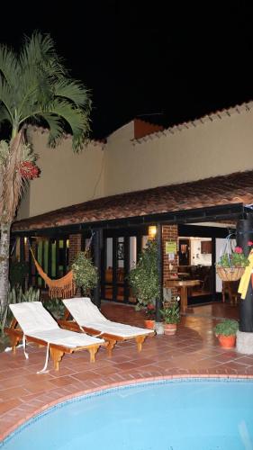 een zwembad met ligstoelen naast een resort bij Finca PANACA Jagüey 12 VIP Group - Villas for Rent in in Quimbaya