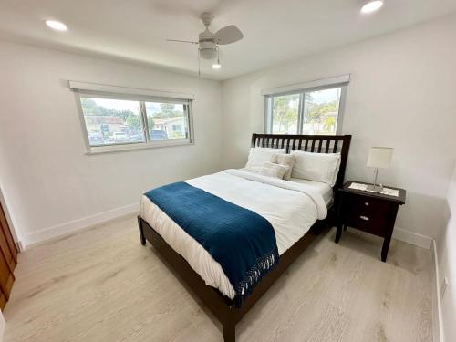 a bedroom with a large bed and a window at Good Vibes House with private pool in Dania Beach