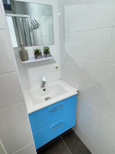 a bathroom with a sink and a mirror at Sweet Dream House in Brussels