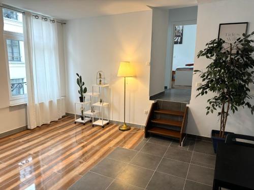 a living room with a lamp and wooden floors at Sweet Dream House in Brussels
