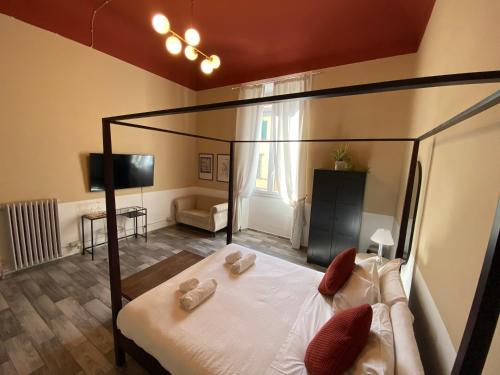 a bedroom with a canopy bed and a living room at Dany House in Florence