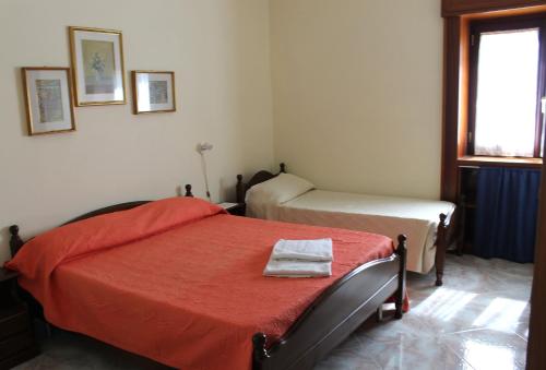 a bedroom with two beds and a window at Casa Annuccia in Agerola