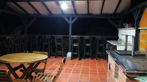 a patio with a table and a table and chairs at Finca PANACA Jagüey 12 VIP Group - Villas for Rent in in Quimbaya