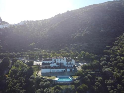 an aerial view of a large house in a mountain at Hotel Rural los Tadeos in Zahara de la Sierra