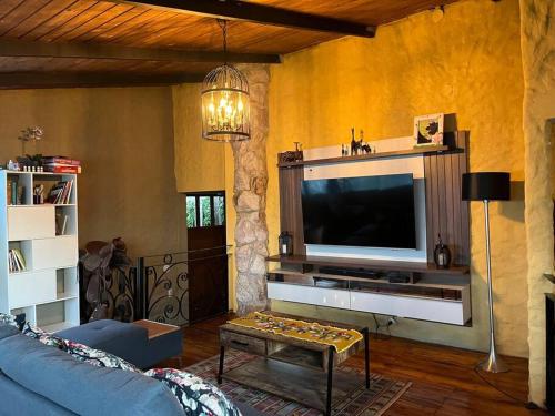 a living room with a blue couch and a tv at Casa de campo - Fundo El Alisal in Cajamarca