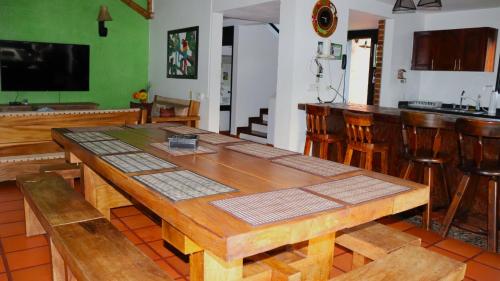 a dining room with a wooden table and chairs at Finca PANACA Jagüey 12 VIP Group - Villas for Rent in in Quimbaya