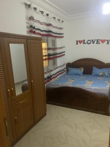 a bedroom with a bed and a mirror at Appartement chambre meublée 1 in Dakar