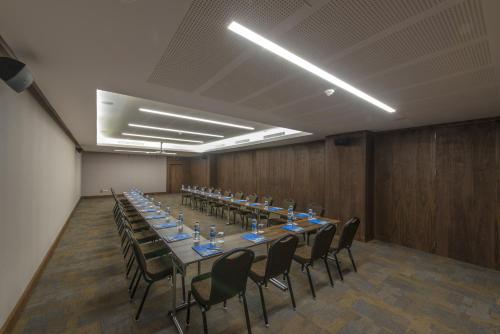 a conference room with a long table and chairs at Le Bleu Hotel & Resort Kusadasi in Kusadası