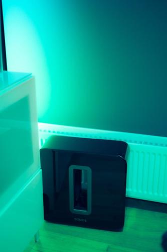 a black clock sitting next to a tv at Smart Luxury - Private Gym, Hot Tub & Sauna in Keflavík