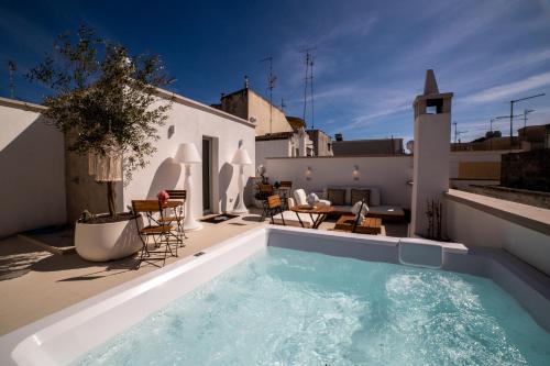 a swimming pool on the roof of a house at Vecchia Mottola Private Suite & Spa in Mottola