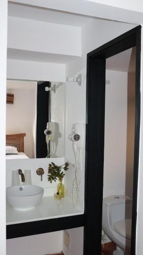 a bathroom with a sink and a mirror at Finca PANACA Jagüey 12 VIP Group - Villas for Rent in in Quimbaya