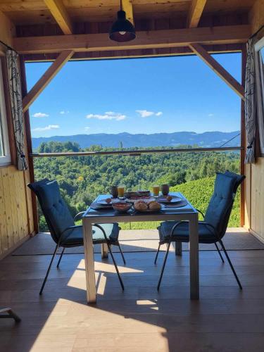 a table and chairs on a porch with a view at Ferienhaus Urschitz in Eichberg Arnfels