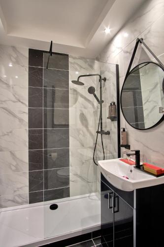 a bathroom with a shower and a sink at Muthu Oban Regent Hotel in Oban