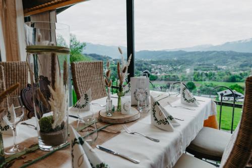 a table with a white table cloth and a view at Gasthof Pension Perauer in Lieserhofen