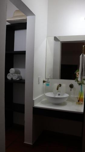 a bathroom with a white sink and a mirror at Finca PANACA Jagüey 12 VIP Group - Villas for Rent in in Quimbaya
