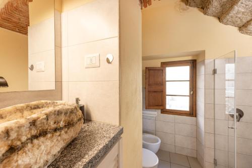 a bathroom with a sink and a toilet at La Fortezza - Goelba in Marciana