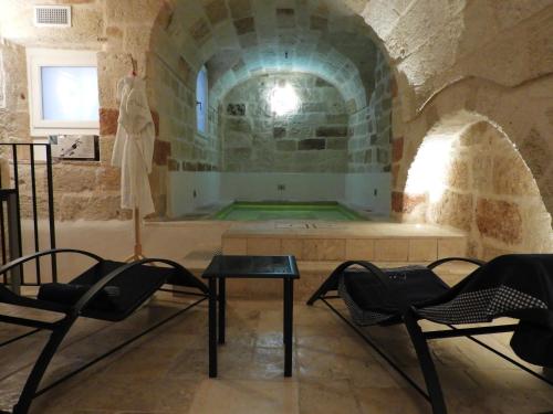a room with chairs and a table in a building at Aeris Suite & Relax in Polignano a Mare