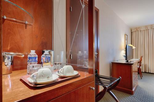 a hotel room with a table with plates and drinks at Evergreen Laurel Hotel in Levallois-Perret