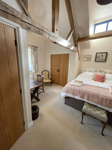 a bedroom with a bed and a table in a room at The Granary in Kington