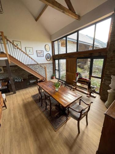 a living room with a wooden table and a staircase at The Granary in Kington