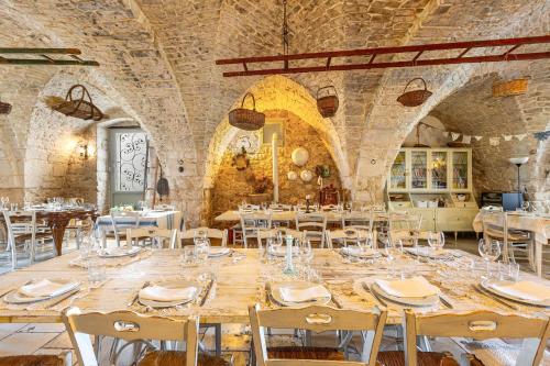 a large dining room with a long table and chairs at Agriturismo Masseria Carrone in Carovigno