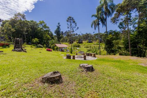a park with some rocks in the grass at Villa Estoril in Campina Grande do Sul