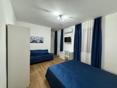 a bedroom with a blue bed and blue curtains at Annabella Bed and Breakfast in Giffoni Valle Piana