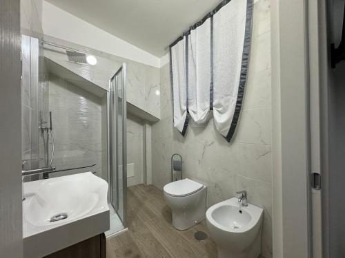 a white bathroom with a sink and a toilet at Annabella Bed and Breakfast in Giffoni Valle Piana