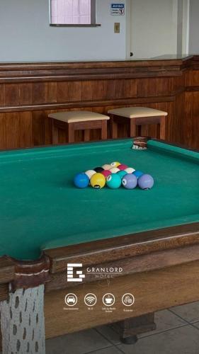 a pool table with balls on top of it at Gran Lord Hotel in Pará de Minas
