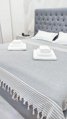 two white towels sitting on top of a bed at Mountain View Two in Tashkent