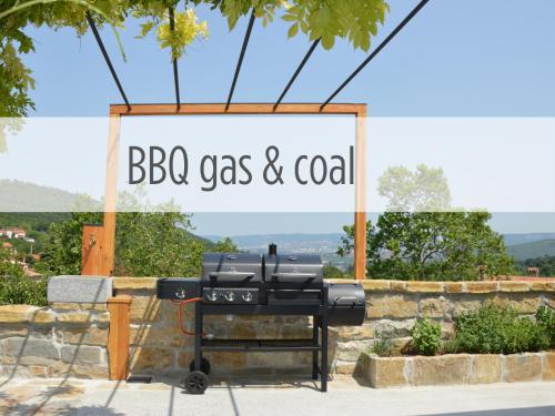 a barbecue grill with a sign that reads bbq gas and coal at Casa Miranda - family comfort in a quiet area, near the sea, with BBQ and FREE parking in Zgornje Škofije