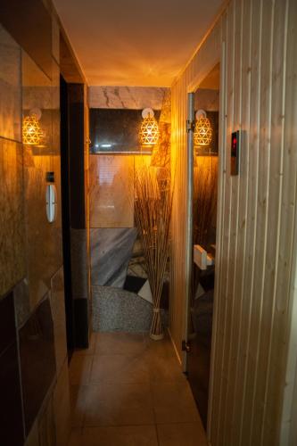a hallway leading to a room with some lights at Checz Gościnna- pokoje,sauna,jacuzzi, sala konferencyjna in Grzybno