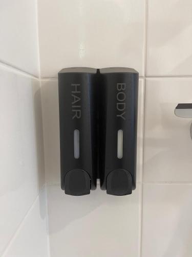 a couple of black dvds sitting on a tile floor at La Pampa - Blow Résidences in Loudéac