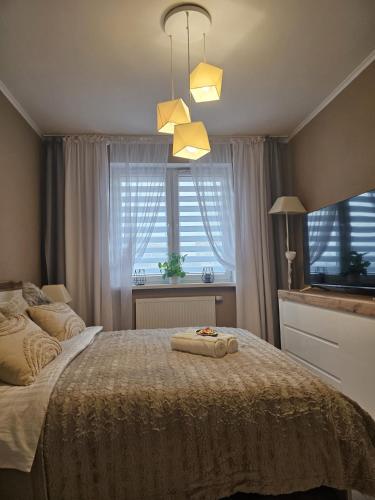 a bedroom with a bed with two towels on it at 2 Bed Apartment in Zyrardow in Żyrardów