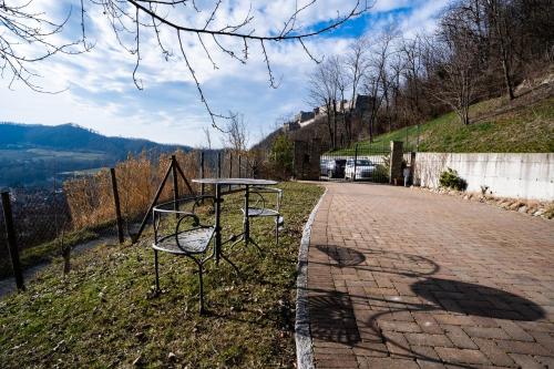a table and two chairs sitting on a brick road at Monte Moro Gavi B&B in Gavi
