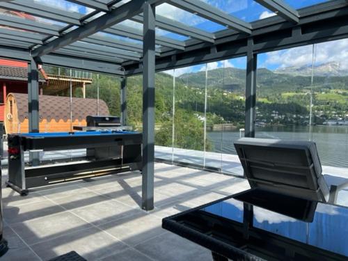 a patio with a table and a bench on a deck at Trolltun, Frystevegen 4 in Ulvik