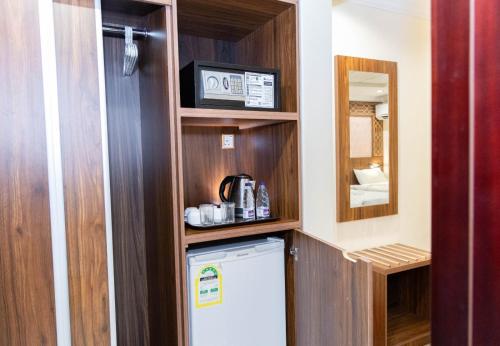 a small kitchen with a refrigerator in a room at Mahd Al Reasala Hotel 1 - فندق مهد الرسالة 1 in Al Khansāk