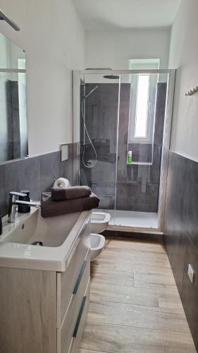 ein Badezimmer mit 2 WCs und einer Glasdusche in der Unterkunft Casa vacanze Mami in Triest