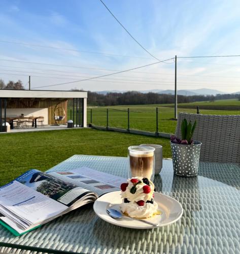 a table with a plate of ice cream and a cup of coffee at Lamelove Apartments - Energylandia, Zator in Chocznia